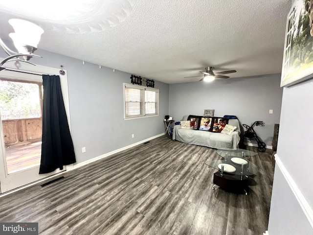 bedroom featuring ceiling fan, a textured ceiling, and multiple windows