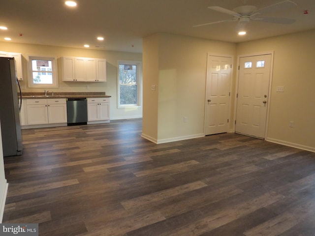 kitchen with sink, ceiling fan, appliances with stainless steel finishes, dark hardwood / wood-style flooring, and white cabinetry