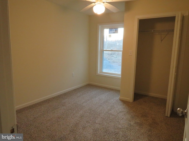 unfurnished bedroom featuring ceiling fan, a closet, and carpet