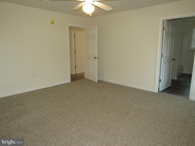 carpeted spare room with ceiling fan