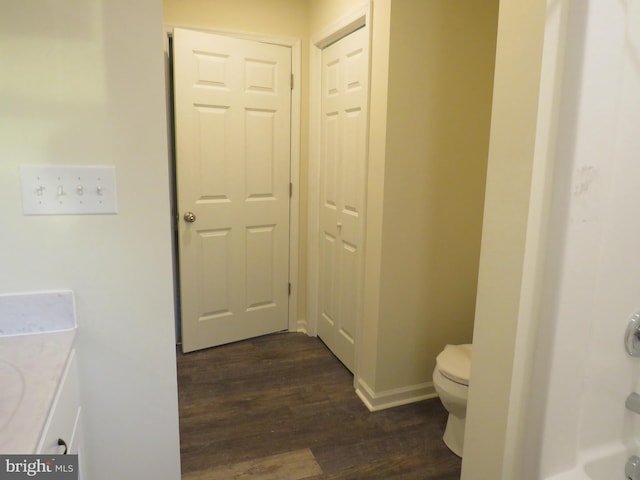 bathroom featuring wood-type flooring, vanity, and toilet