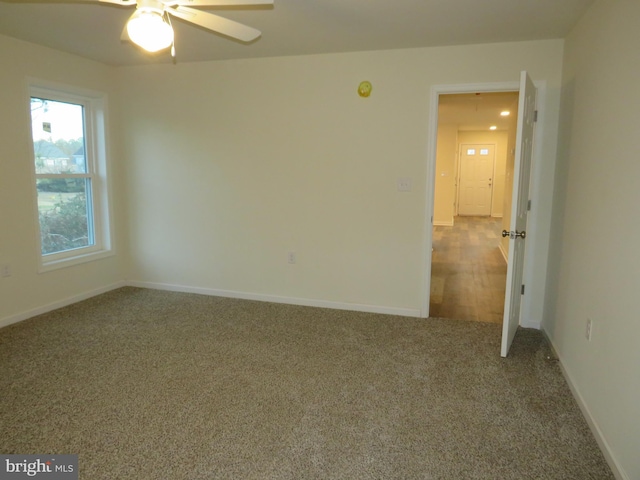 spare room featuring carpet flooring and ceiling fan