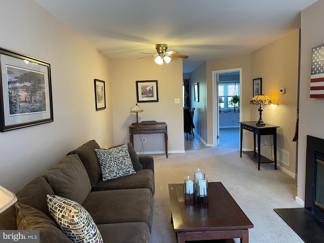 carpeted living room featuring ceiling fan