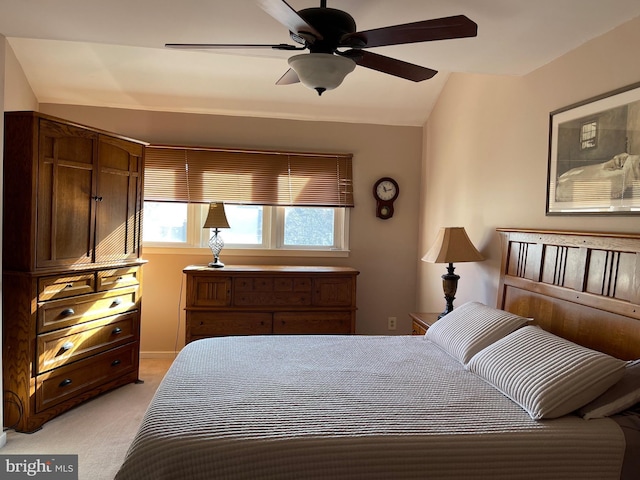 bedroom with light carpet, vaulted ceiling, and ceiling fan