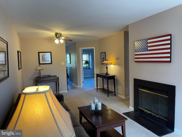 living room featuring carpet flooring and ceiling fan