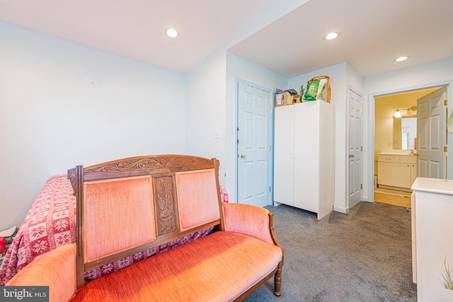 bedroom with dark colored carpet and ensuite bath