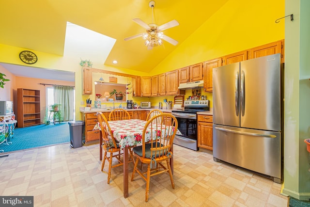 kitchen featuring ceiling fan, high vaulted ceiling, and appliances with stainless steel finishes