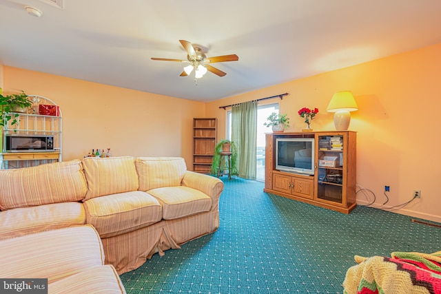 living room featuring carpet flooring and ceiling fan