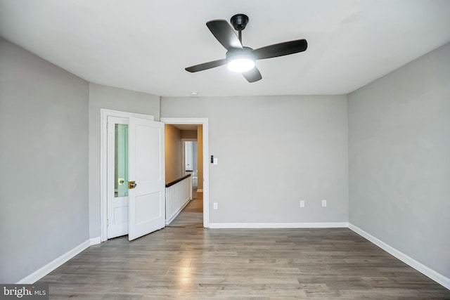 unfurnished room featuring ceiling fan and hardwood / wood-style floors