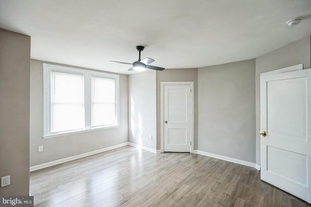 empty room featuring ceiling fan and light hardwood / wood-style floors