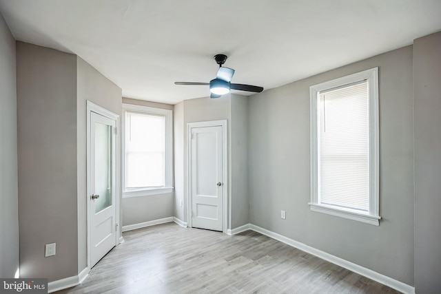 unfurnished bedroom with ceiling fan and light hardwood / wood-style flooring