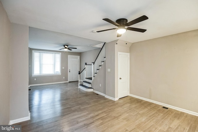 unfurnished living room featuring light wood-type flooring and ceiling fan