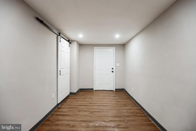 interior space with hardwood / wood-style flooring and a barn door