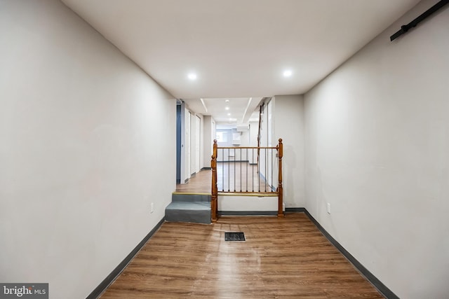 corridor with wood-type flooring