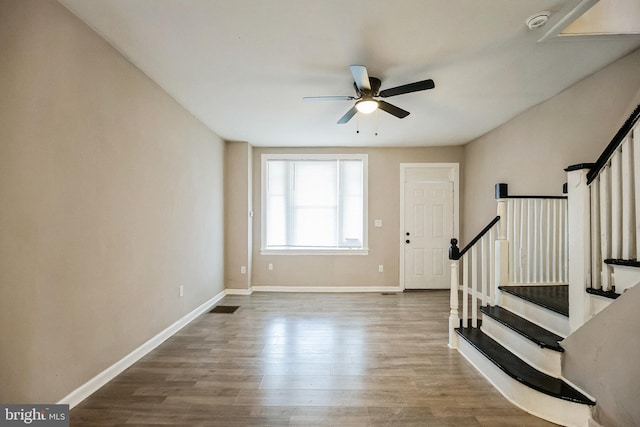 foyer entrance with wood-type flooring and ceiling fan