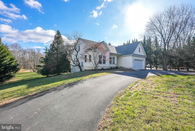 view of front of house with a garage and a front lawn