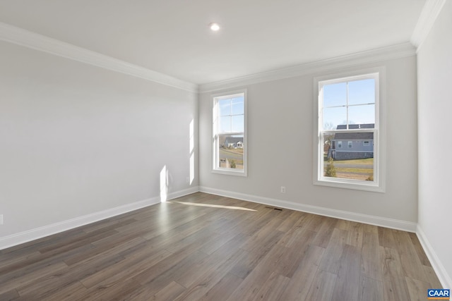 spare room featuring hardwood / wood-style floors and ornamental molding