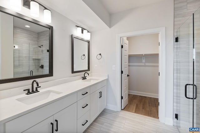 bathroom with vanity and walk in shower