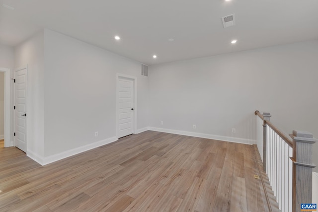 unfurnished room with light hardwood / wood-style floors