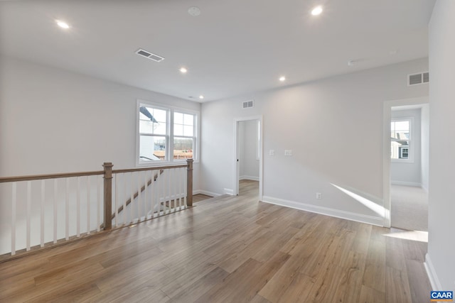 unfurnished room with light hardwood / wood-style flooring