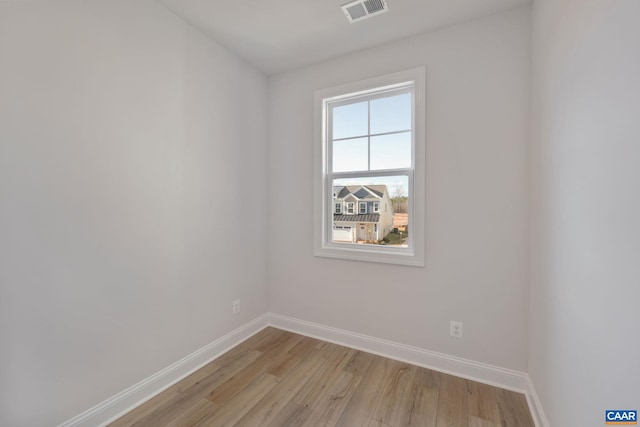 spare room with light hardwood / wood-style floors