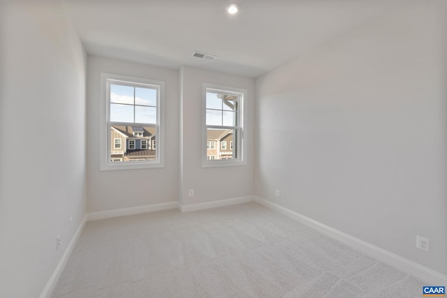 unfurnished room with light colored carpet