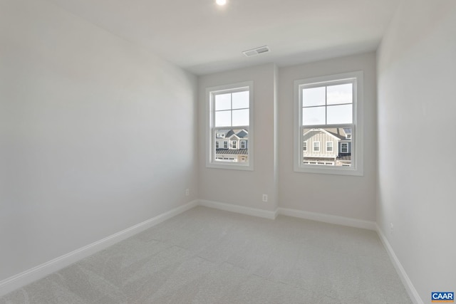 unfurnished room featuring light carpet