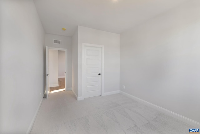 unfurnished bedroom featuring light carpet