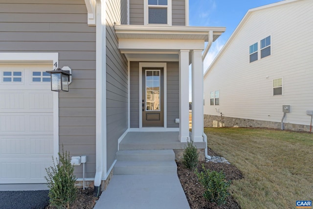 view of exterior entry with a garage