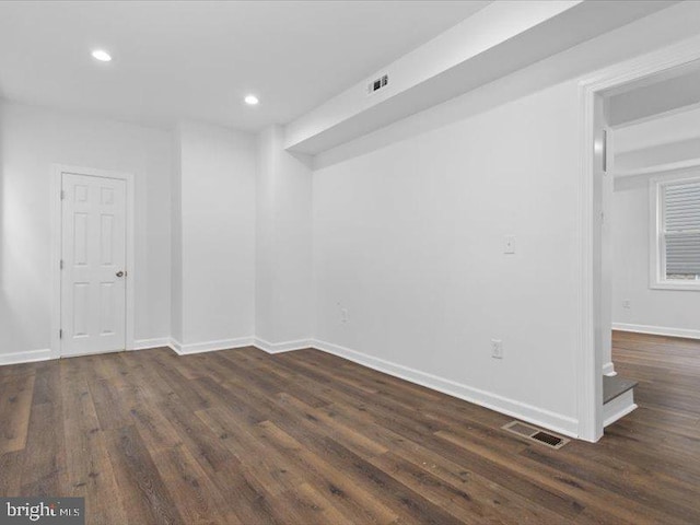 spare room featuring dark hardwood / wood-style flooring