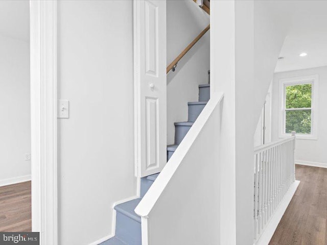 stairway featuring hardwood / wood-style flooring