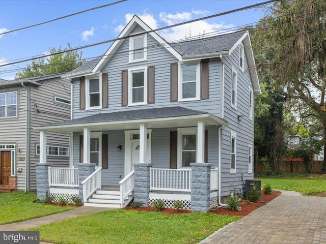 view of front of home featuring a front yard and a porch