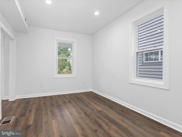 unfurnished room featuring dark hardwood / wood-style floors