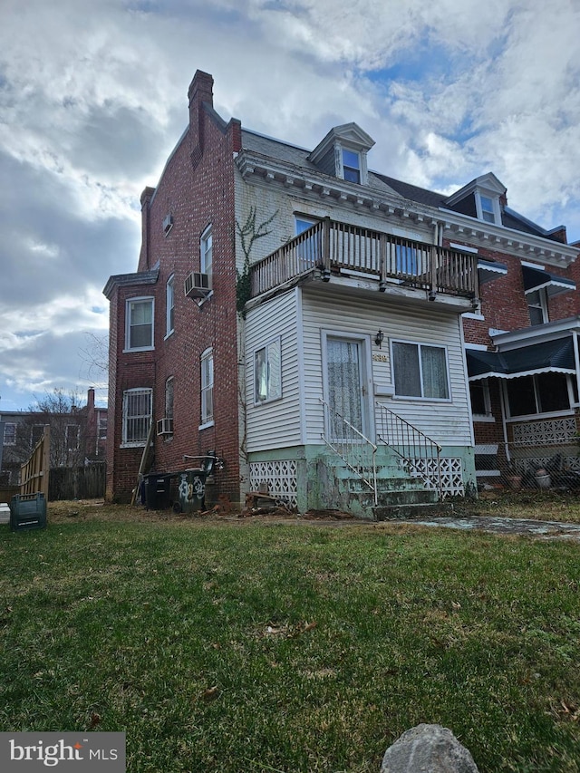 exterior space featuring a yard and a balcony