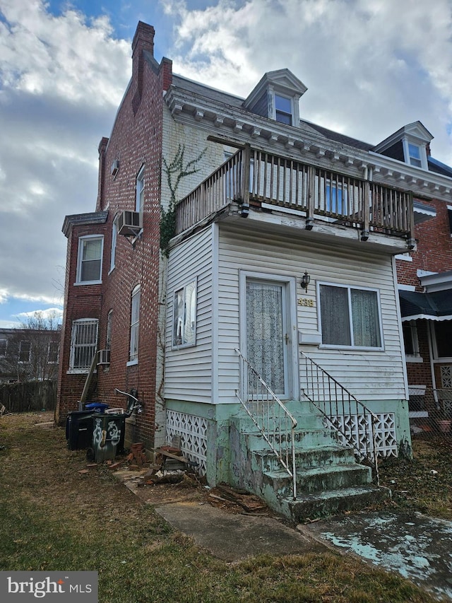 rear view of property with a balcony