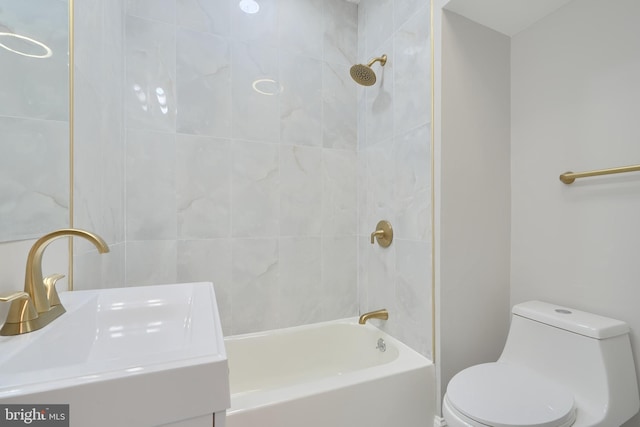 full bathroom featuring sink, tiled shower / bath combo, and toilet