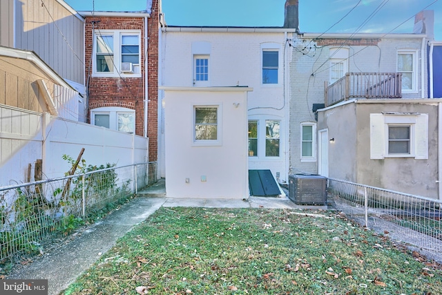 rear view of house with a balcony and cooling unit