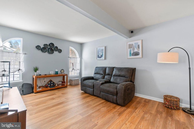 living room featuring beamed ceiling and hardwood / wood-style floors