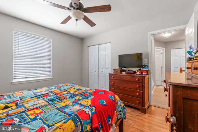 bedroom with light hardwood / wood-style flooring, a closet, and ceiling fan