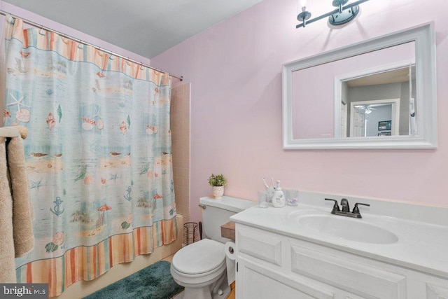 full bathroom with toilet, vanity, and shower / bath combination with curtain