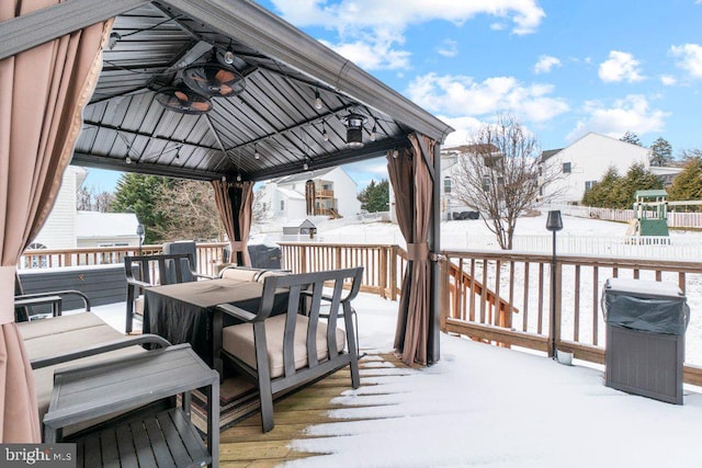 snow covered deck with a gazebo and area for grilling