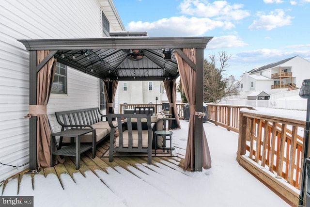 snow covered deck featuring a gazebo