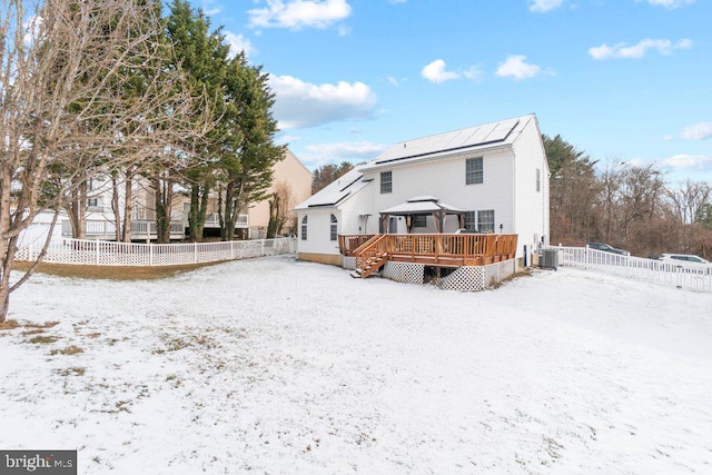 snow covered house featuring central air condition unit and a gazebo