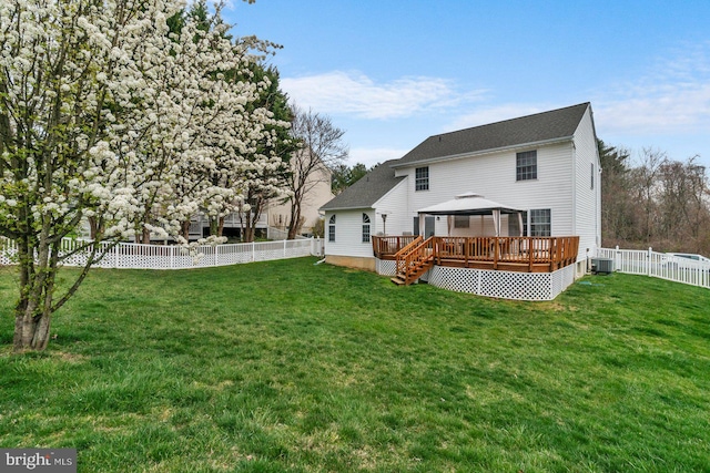 back of house with a lawn, central air condition unit, and a gazebo