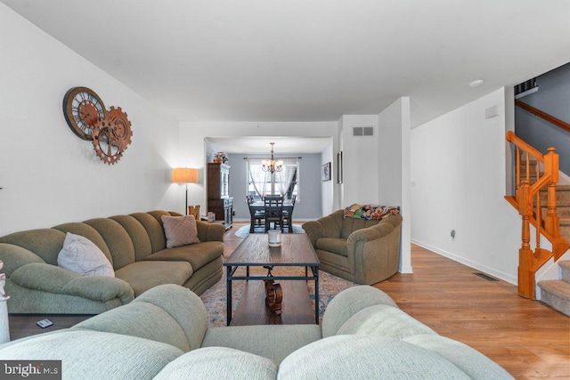 living room featuring wood-type flooring and a chandelier