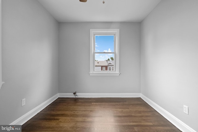 empty room with dark hardwood / wood-style flooring