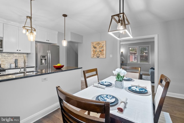 dining room featuring sink and dark wood-type flooring