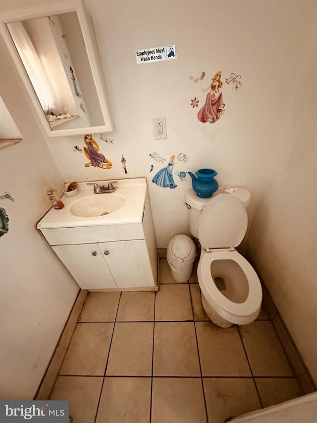 bathroom with tile patterned floors, vanity, and toilet