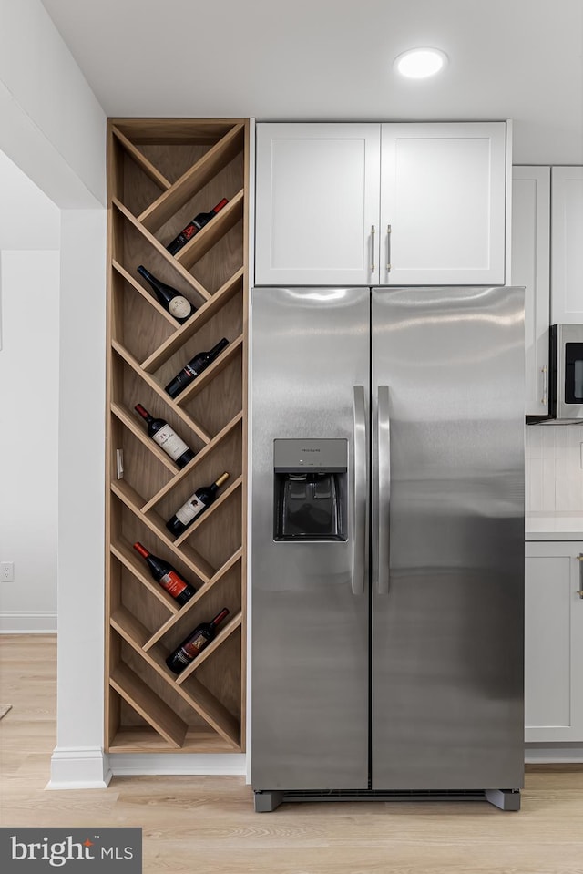 interior space with recessed lighting, light wood-style flooring, and baseboards