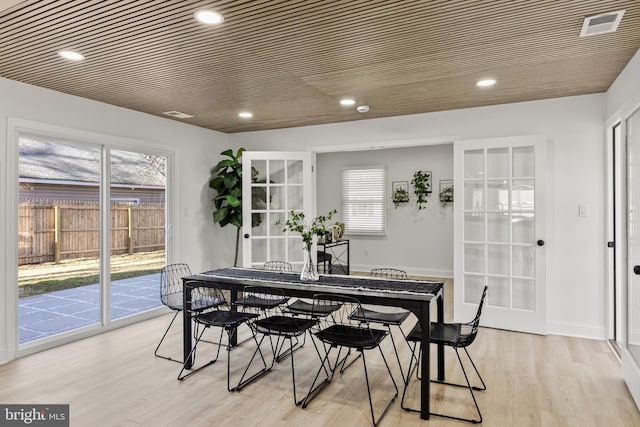 dining room featuring wooden ceiling, french doors, and light hardwood / wood-style flooring